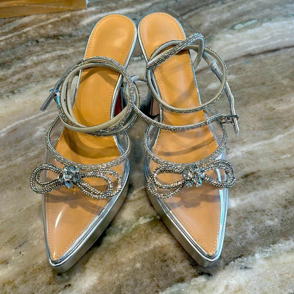 Silver platform shoes with rhinestone detail, and clear plastic toe